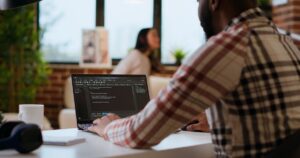 The Tech Job Everyone Thought Was Safe From AI Is Quietly Being Hollowed Out Man using laptop