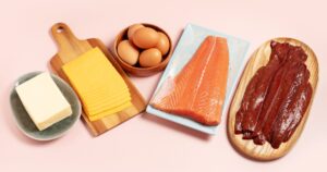 The US Flipped the Food Pyramid — Here’s What The Guidelines Say and What Experts Think Meat, dairy, fish and eggs with pink background