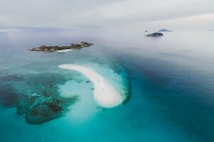 What to Know About Jared Kushner and Ivanka Trump's Island Retreat Stunning aerial photo of tropical islands and sandbar with clear blue water.