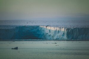 Explore the breathtaking beauty of an arctic glacier in a tranquil winter scene, capturing nature's icy splendor.