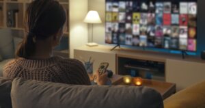 Little-known TV Feature May Be Spying on You. Change It Immediately Woman watching TV in living room