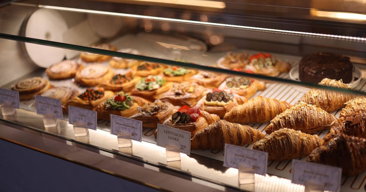 A tempting display of assorted pastries and croissants in a bakery showcase.