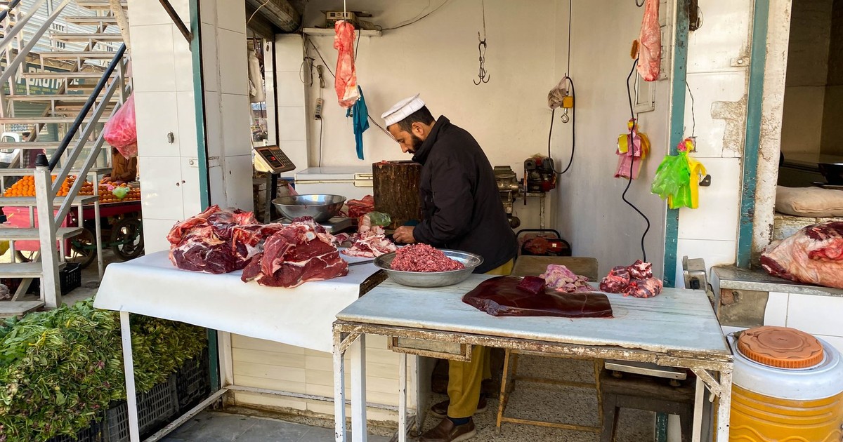 Butcher preparing fresh halal meat at a local market in Mingora, Pakistan.