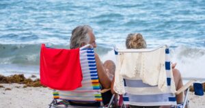 3 Retirement Rules the US Government Just Changed - What Every American Senior Should Know Senior couple relaxing on Miami Beach, enjoying the ocean view and summer sunshine.