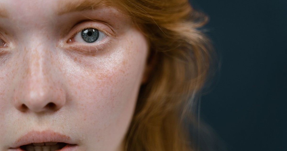 A close-up of a woman's face showing an emotional expression, highlighting her eye and skin texture.
