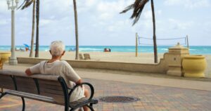 Will Florida's Retiree Boom End? Here's Where People Are Moving Instead Elderly retired man enjoying the sights of the beach.