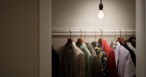 Closet with Clothes and Bare Lightbulb