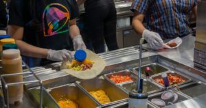 New York NY/USA-April 23, 2019 Workers prepare food in the Taco Bell Cantina restaurant in Midtown Manhattan in New York
