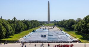 Washington, D.C. United States - May 12, 2026: Tourists standing in front of the Lincoln Memorial look out over the Reflecting Pool as renovation work, including, resurfacing and painting, is ongoing