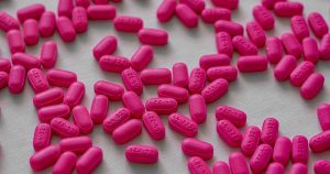 ADHD Medication and Heart Risk: What Millions of Adults Need to Know Close-up view of pink tablets scattered on a white table for medication and health treatment.