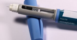 3 Diabetes Drugs That May Help Lower Dementia Risk in People With Type 2 Diabetes Detailed view of a semaglutide injection pen, commonly used for diabetes treatment, on a plain background.