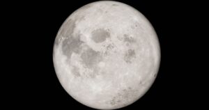 Detailed image of a full moon against a black night sky, showcasing lunar features.