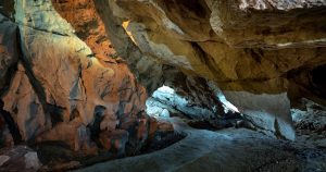 Explore the mesmerizing beauty of a natural cave with stunning rock formations and captivating textures.