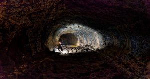 Mysterious Ancient Tunnel System Discovery Has Archeologists Scratching Their Heads Explore the depths of a cave tunnel with dramatic lighting and intricate textures.