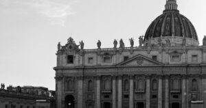 A classic black and white photo of St. Peter's Basilica in Vatican City featuring stunning architectural details.