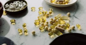Popular Fiber Supplement May Not Be Suitable for Fatty Liver Disease A close-up of assorted pills and supplements arranged on a marble surface, highlighting healthcare and wellness themes.