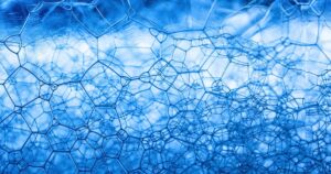 Water Might Actually Be Two Different Liquids — Here's the Science Detailed close-up of blue soap foam showcasing abstract geometric patterns and texture.