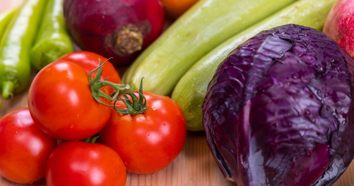 A vibrant assortment of fresh, organic vegetables on a wooden table, perfect for healthy eating.