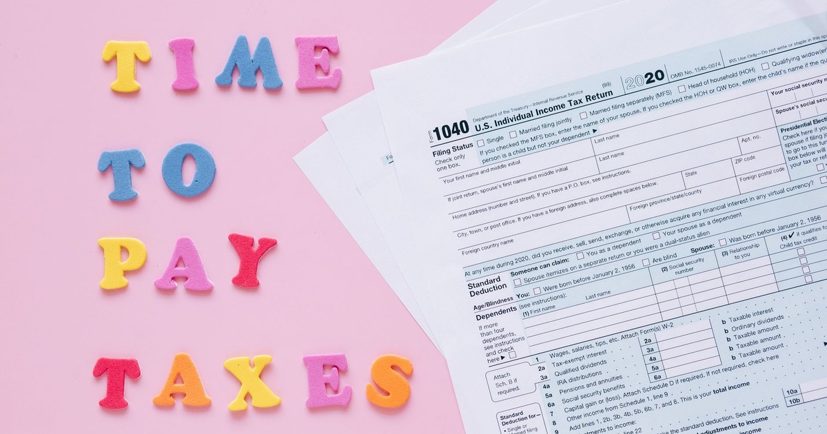 1040 tax forms with colorful 'Time to Pay Taxes' letters.