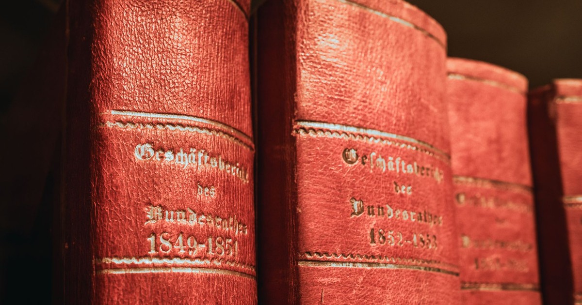 Red leather-bound parliamentary books from 19th century in Bern library, Switzerland.