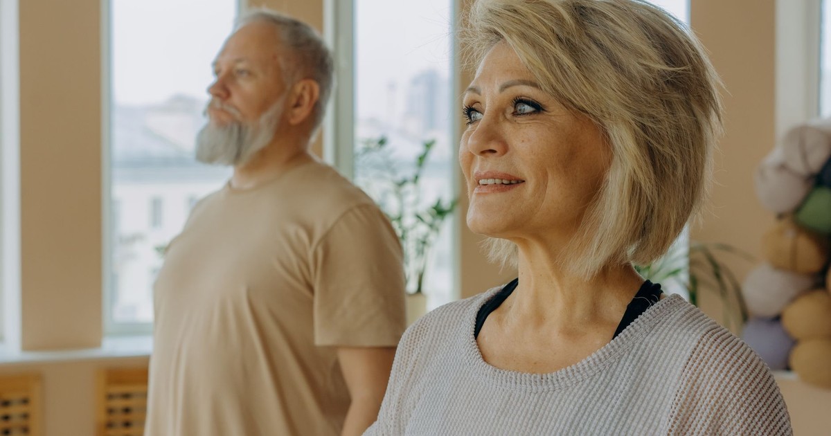 Senior couple at a wellness studio enjoying yoga and relaxation indoors.