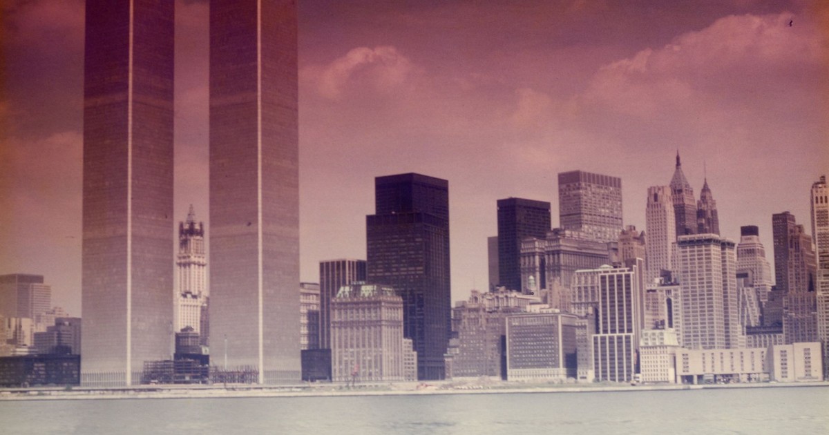Vintage view of Manhattan skyline featuring the Twin Towers and surrounding skyscrapers across the water.