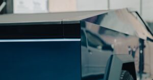 What Happened to the 1,000+ Tesla Cybertrucks at SpaceX? A Visitor Found Out Close-up view highlights the sleek and futuristic design of a modern cybertruck in Bucharest.