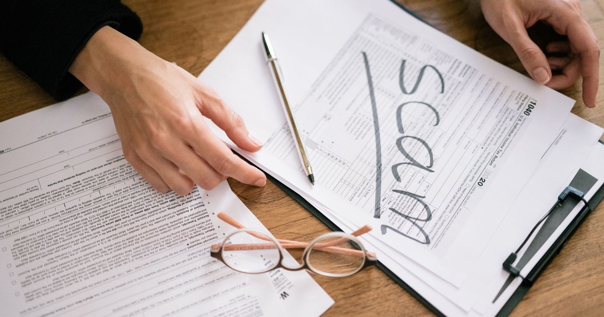 A close look at tax forms marked with scam, highlighting financial fraud risks.