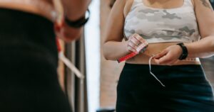 90% of U.S. Adults Have This Syndrome — and Most Have Never Heard of It Low angle of crop faceless overweight female in activewear reflecting in mirror in sports club