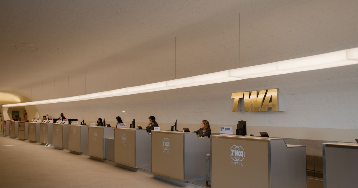 Reception desks at TWA Hotel, showcasing retro-modern design in JFK Airport, New York.