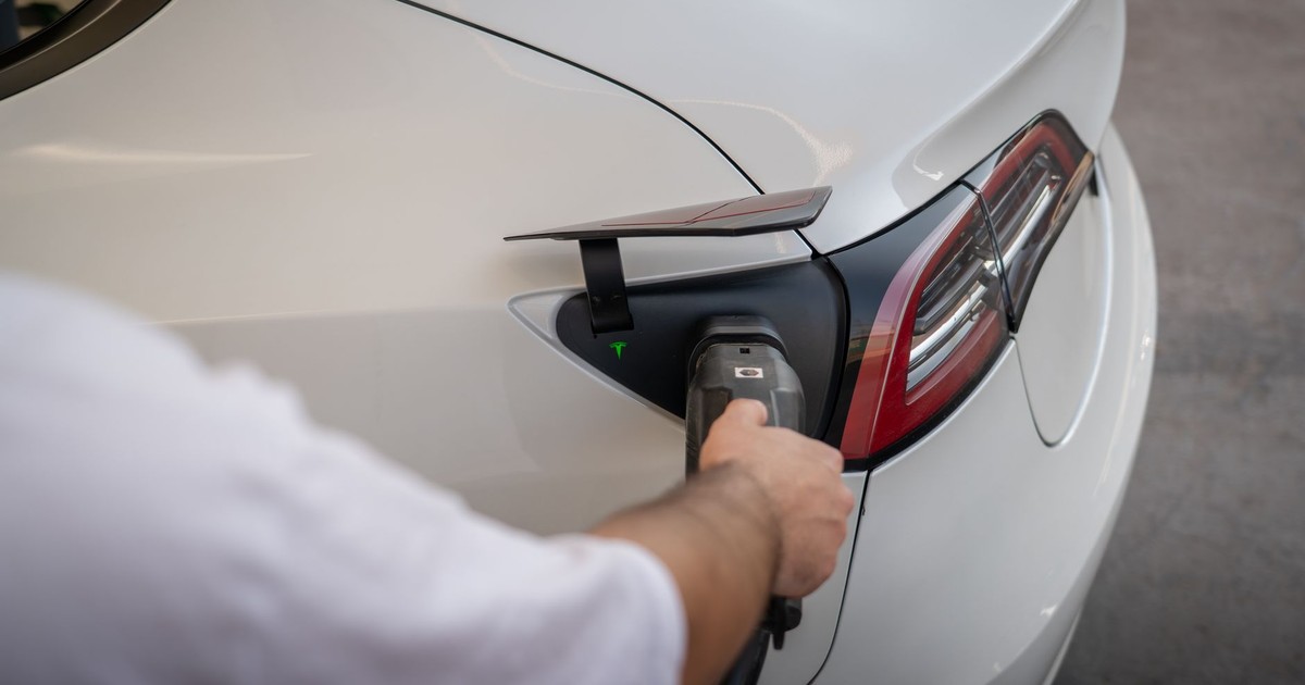 Close-up of an electric car being charged, emphasizing modern sustainable technology.