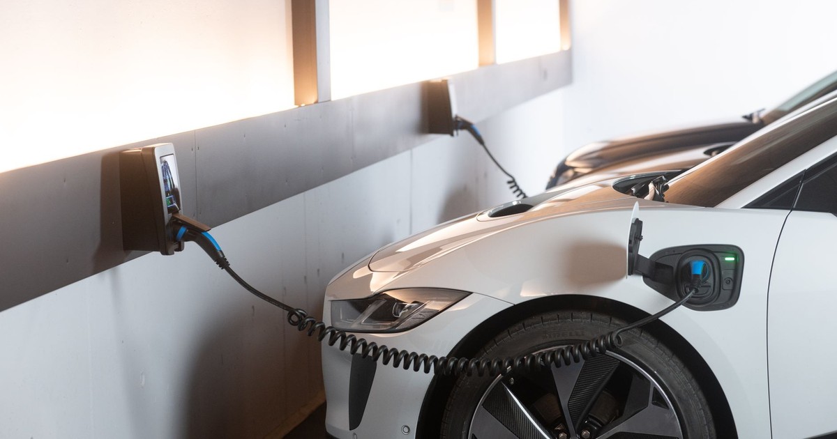 Electric car charging in a modern indoor station promoting sustainability and energy efficiency.