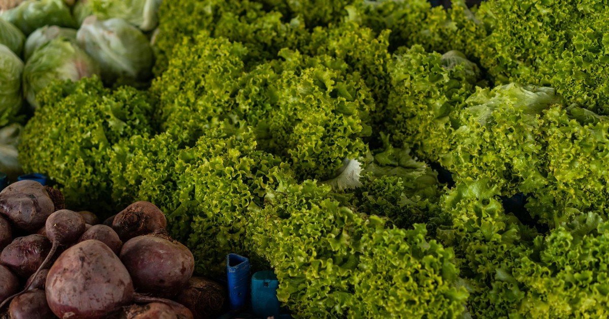 Close-up of various fresh vegetables including lettuce and beets at a market.