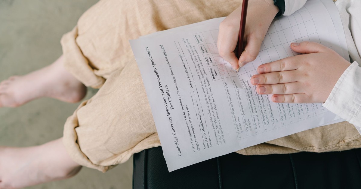 Young child completing a questionnaire indoors for educational purposes.