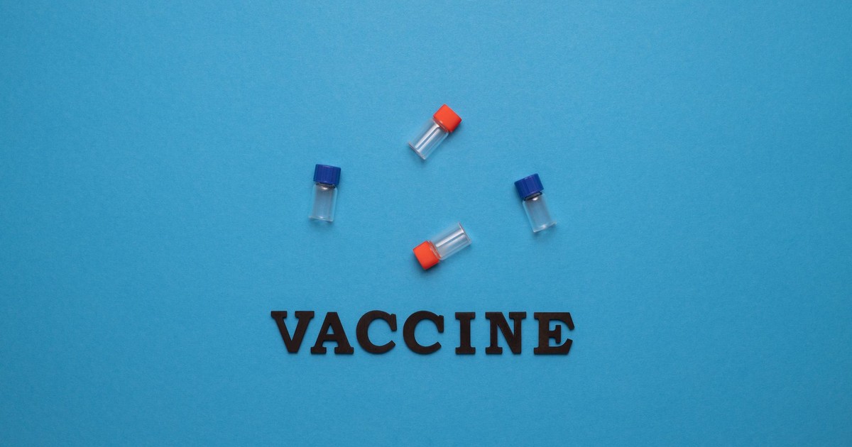 Three small vials and the word 'VACCINE' on a blue background, representing vaccination and health.