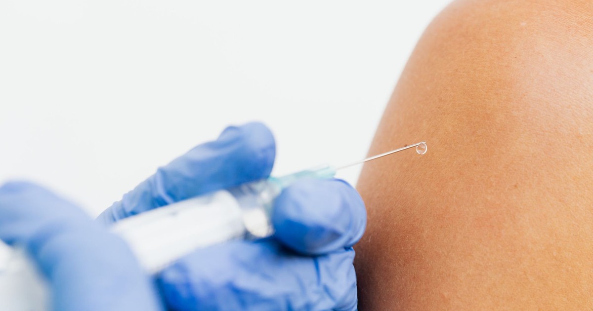 Close-up of a healthcare professional administering a vaccine.