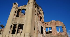 The Hiroshima Atomic Bomb Dome against a clear blue sky, symbolizing peace and history.