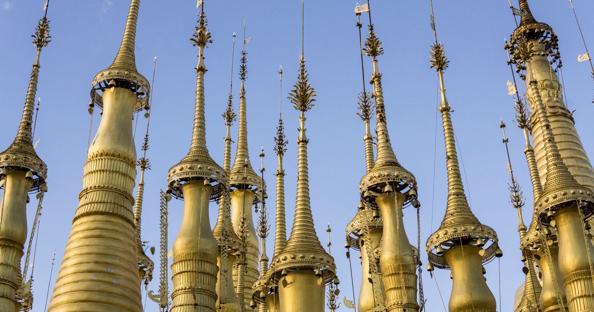 Capturing the elegant golden stupas under the clear blue sky in Shan, Myanmar.