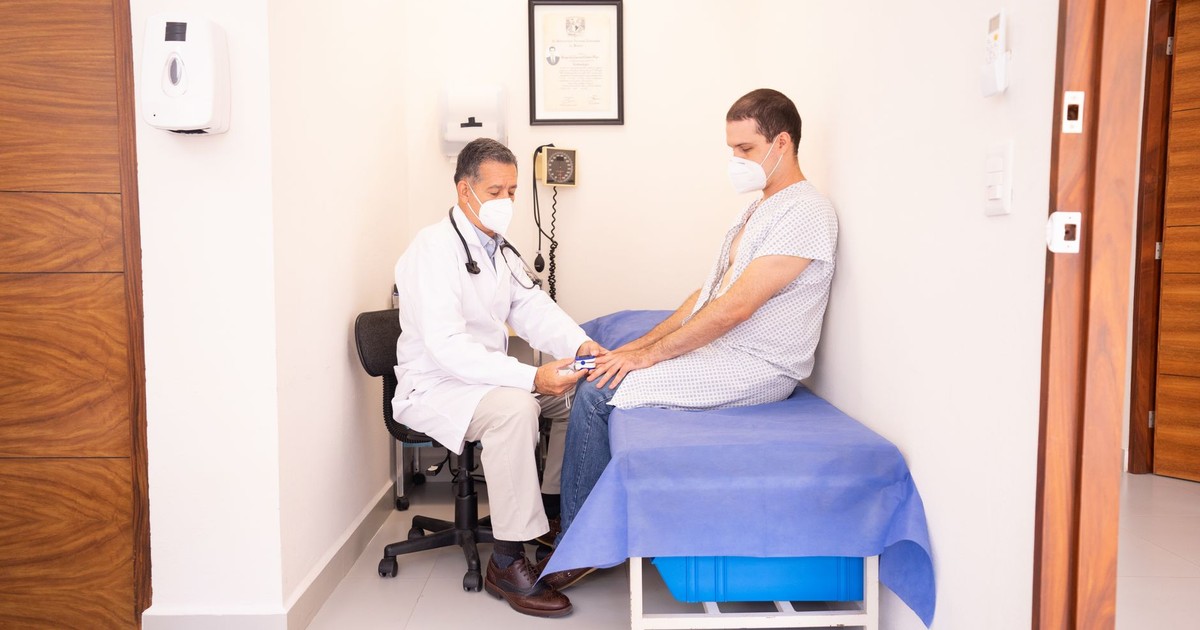Doctor checking patient's vitals in a clinical setting for health consultation.
