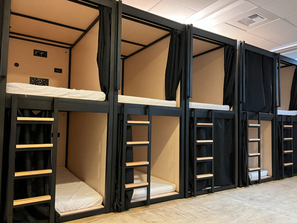 Rows of compact sleeping pods inside Brownstone Shared Housing in San Francisco.
