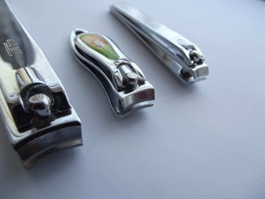Three pairs of nail clippers in various sizes. 